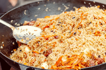 Cooking delicious pilaf, traditional Central Asian cuisine