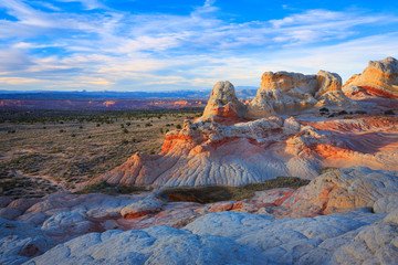 The last light of day hits the colorful landscape of White Pocket, Arizona in the Vermilion Cliffs National Monument