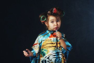 Portrait of a little fashionable girl in curlers .The concept of femininity
