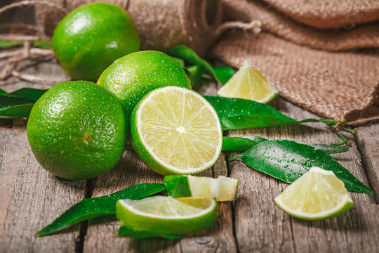  Fresh ripe limes on wood, rich source of Vitamin C, often used to accent of food and beverages