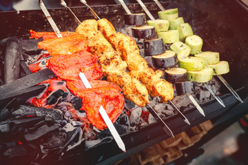 Cooking delicious meat with vegetables on barbecue