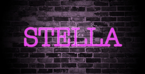 first name Stella in pink neon on brick wall