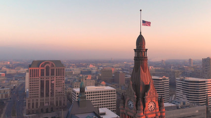 Aerial view of american city at dawn. Downtown Milwaukee, Wisconsin, United States. Drone shots, sunrise. Flag of the United States - obrazy, fototapety, plakaty