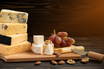 Various types of cheese on a rustic table