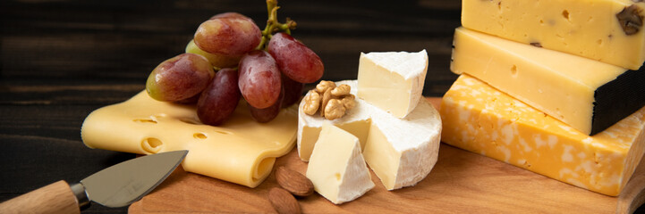 Various types of cheese on a rustic table