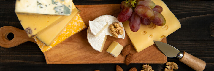 Various types of cheese on a rustic table