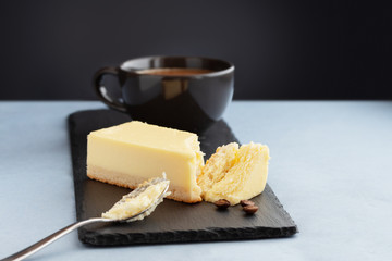 a piece of cheesecake and a cup of coffee for breakfast