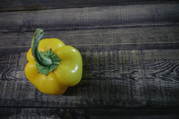 yellow pepper on wooden background