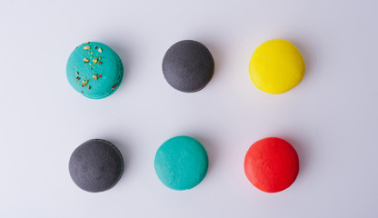 Colorful french macaroons isolated on white background. Top view