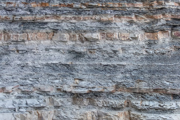 Texture Or Background Of Cut Of Breakaway Rock. Layers Of Rock Cut. Grey Layered Background