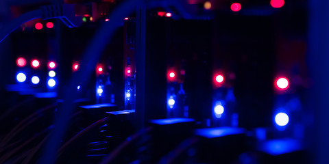 Equipment For Mining Crypto Bitcoin Token, Etherium Cash Close-up. Electronic Boards And Chips, Blue And Red Lights. Blurred Server Lights