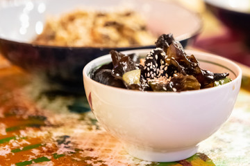 Asian Cuisine - Rice In Sauce With Stir Fried Vegetables With Mushrooms And Sesame In Bowl. Close-Up.