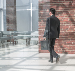 businessman walks in his office