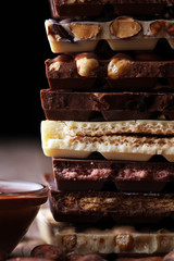 Chocolate bars on table with chocolate tower.