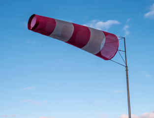 Windsock during a strong wind. Windsock shows wind direction and strength. Made of fabric in the...
