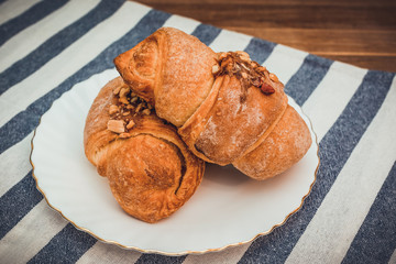 Fresh homemade croissant on wooden table