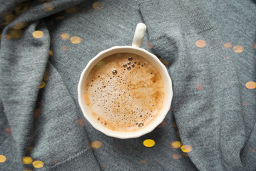A cup of fresh coffee with beautiful foam on grey background. Flat lay style.