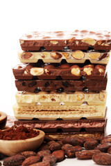 Chocolate bars on table with chocolate tower.