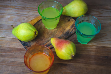 soda pop in a glass cup next to a pear