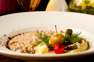  nostroganov with mushrooms in a creamy sauce, spur and gherkins