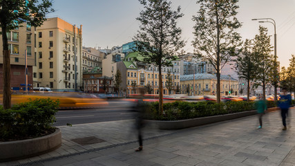 the flow of pedestrians and cars following the city street