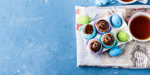 Easter background with cakes in eggs