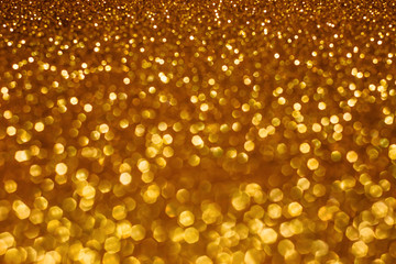 Christmas holiday abstract bokeh background with gold lights. Glitter golden bokeh background