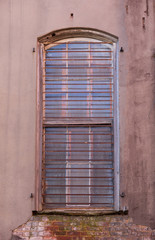 Old window with bars , in masonry wall