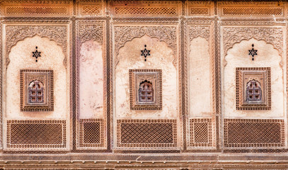 Patterns with ancient examples of decorations on wall of historical house in Rajasthan, India