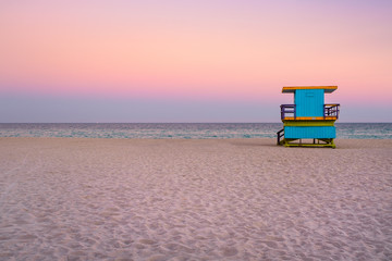Famous lifeguard tower at South Beach in Miami with a beautiful sunset sky
