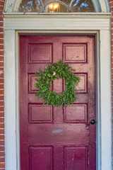 Fototapeta na wymiar Green Summer Wreath on Red Door