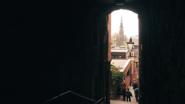 Edinburgh, Scotland / United Kingdom - August 2014: The Scott Monument seen from the Royal Mile through a narrow alley