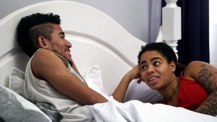 An African American couple of lovers spends their day, black people fall in love with each other, the romantic atmosphere of young progressive people, bed scene, the moment before sex - Powered by Adobe