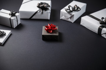 White gift box on a dark contrasted background, decorated with a textured bow, creating a romantic atmosphere.