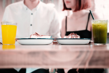 young couple having breakfast in the kitchen