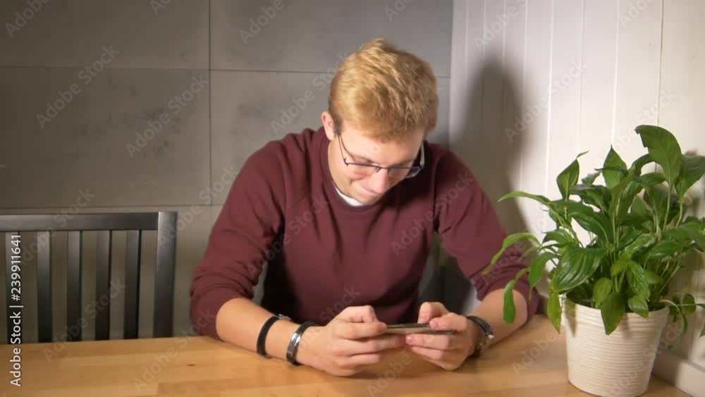 Aufkleber man intensely playing the mobile game. using smartphone horizontally. losing the game