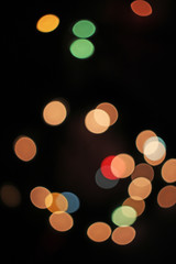 Blurred defocused christmas light lights bokeh background. Colorful red yellow blue green de focused glittering pattern concept.