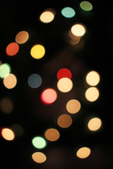 Blurred defocused christmas light lights bokeh background. Colorful red yellow blue green de focused glittering pattern concept.