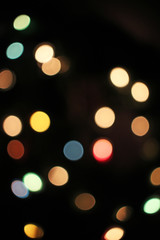 Blurred defocused christmas light lights bokeh background. Colorful red yellow blue green de focused glittering pattern concept.