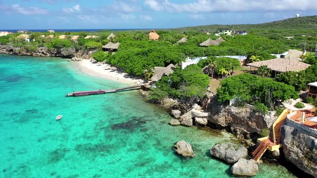 Aerial View of the Tropical Coastline of Cura&radic;&szlig;ao of the Caribbean Islands with Straw Huts, Pristine Beaches, and Vibrant Water Colors