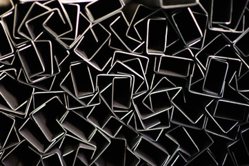 Abstract geometric background. Metal rectangles on a dark background.