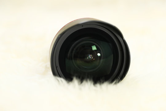 New Jersey, USA - December 20, 2018: 11mm -24mm f/2.8 Canon EF Mount Lens isolated on a white surface and with other Canon lens at the background - Image