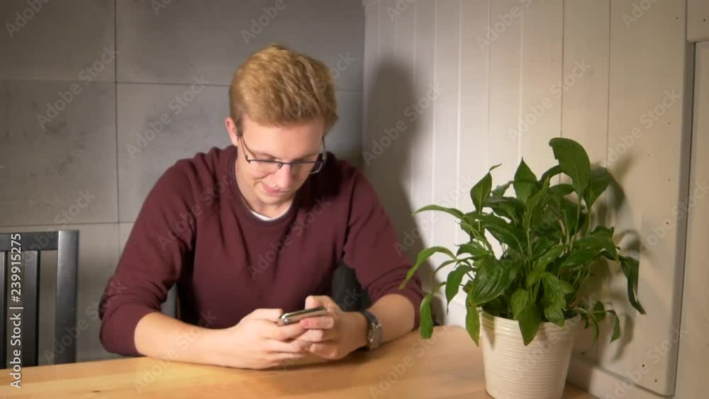 Aufkleber man intensely playing the mobile game. using smartphone vertically. winning the game