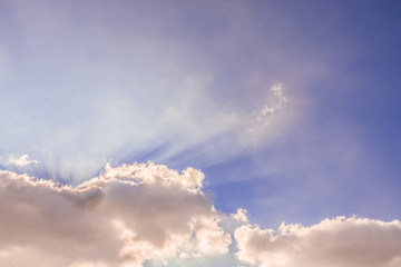 Beautiful beam of light and the fluffy clouds. Blue sky with sun rays