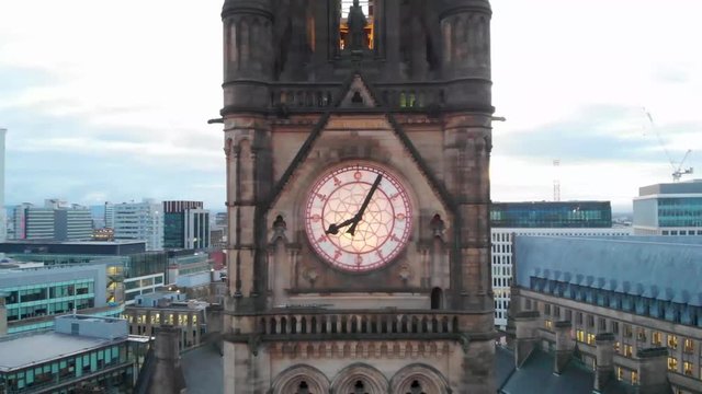 4K Drone aerial shot flying over Manchester Town Hall Albert Square Panning back from the clock tower during the early cold morning.