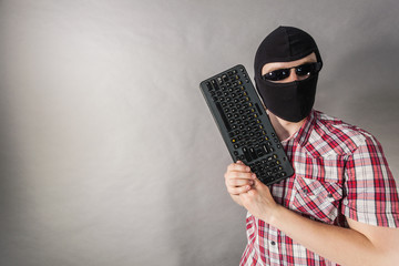 Man wearing balaclava shooting from keyboard