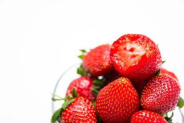 The glass bowl filled with red strawberries