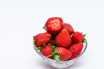 The glass bowl filled with red strawberries
