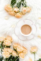 Composition of pastel tea rose bouquet flowers and a Cup of cocoa on white background. Floral background. Flat lay, top view.  