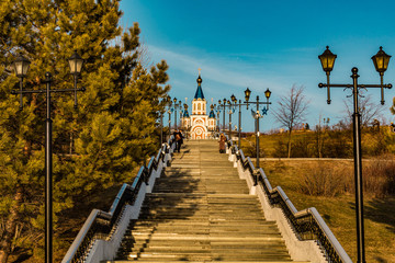 Stairs from the embankment of the Amur river.